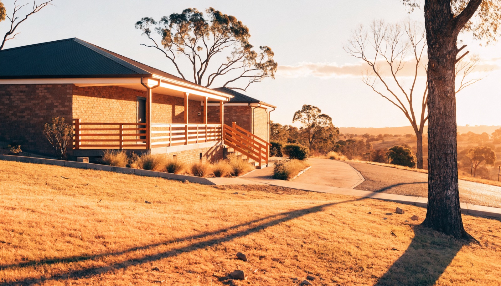 A finished concrete driveway leading up to a rural Tasmanian home