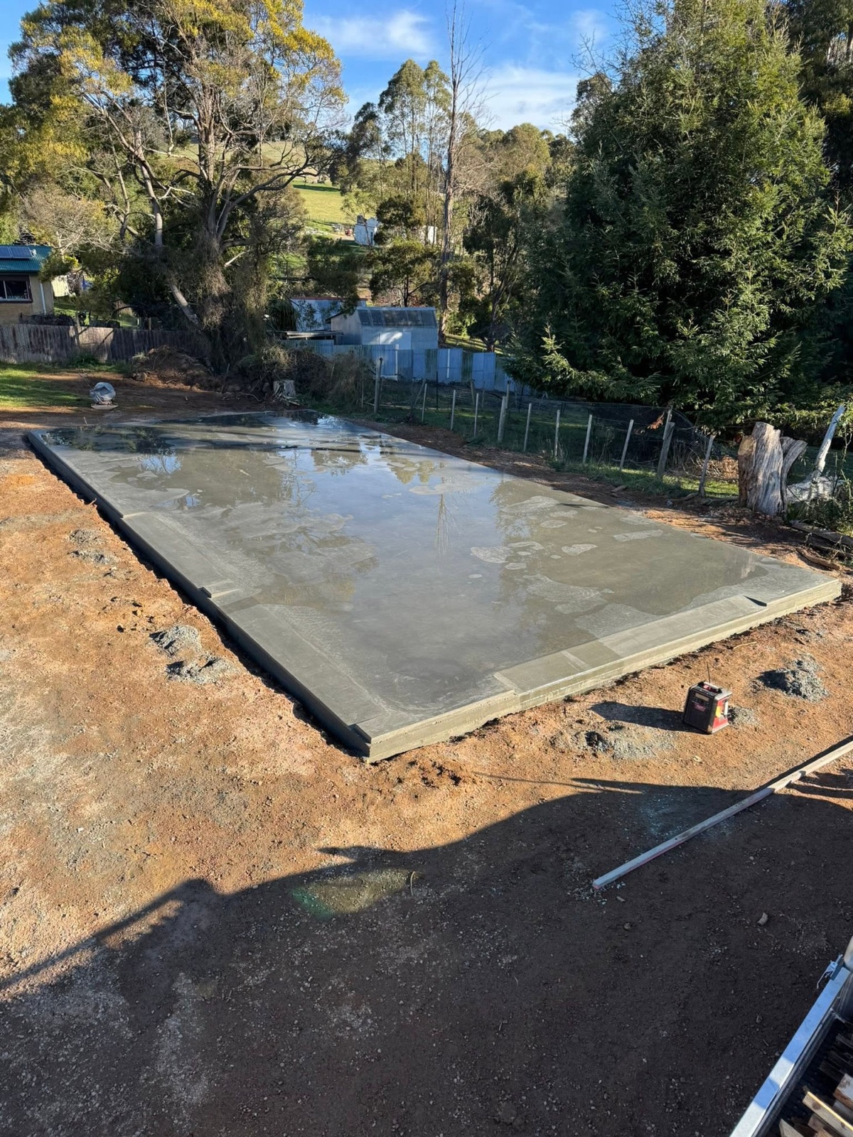 A freshly poured house slab curing on a rural block