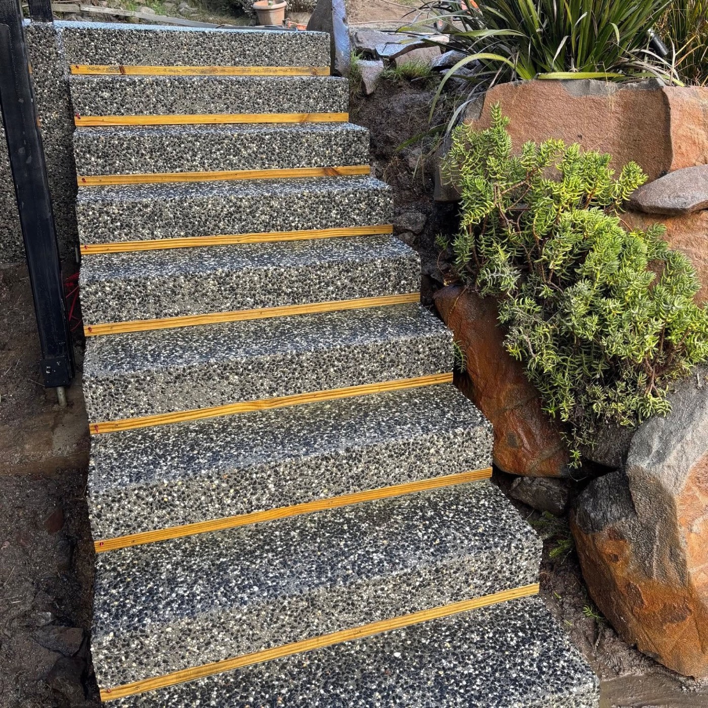 Exposed aggregate steps set into a landscaped garden