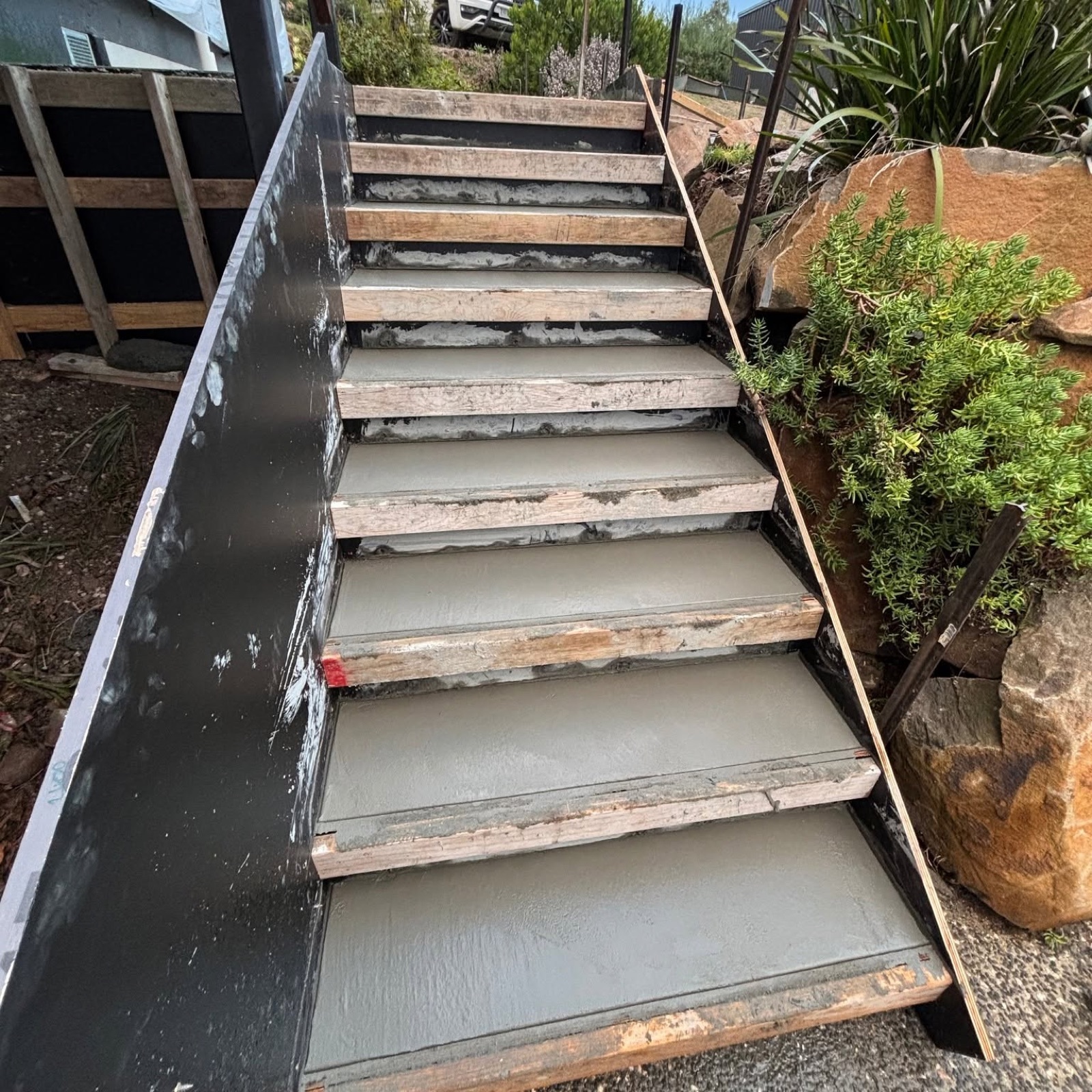 Concrete steps freshly poured with timber formwork still in place